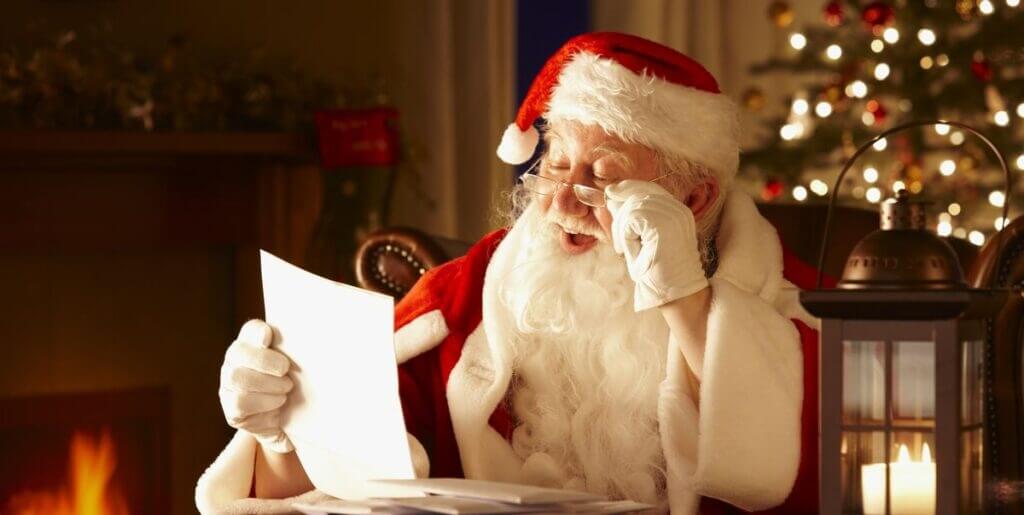 Santa Claus reading a paper of wishes